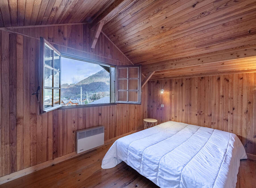 This charming bedroom boasts a cozy, wood-paneled interior, creating a warm and inviting atmosphere.
