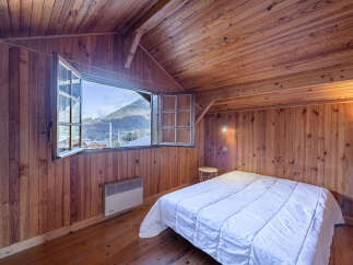 This charming bedroom boasts a cozy, wood-paneled interior, creating a warm and inviting atmosphere.