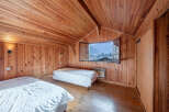 This cozy bedroom features beautiful wooden paneling throughout, creating a warm and inviting atmosphere.