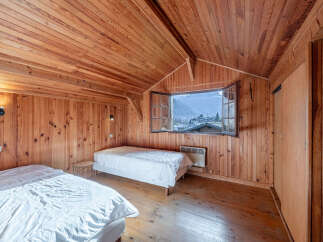 This cozy bedroom features beautiful wooden paneling throughout, creating a warm and inviting atmosphere.