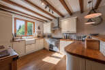 This stunning kitchen boasts a warm and inviting atmosphere, perfect for culinary creations and family gatherings.