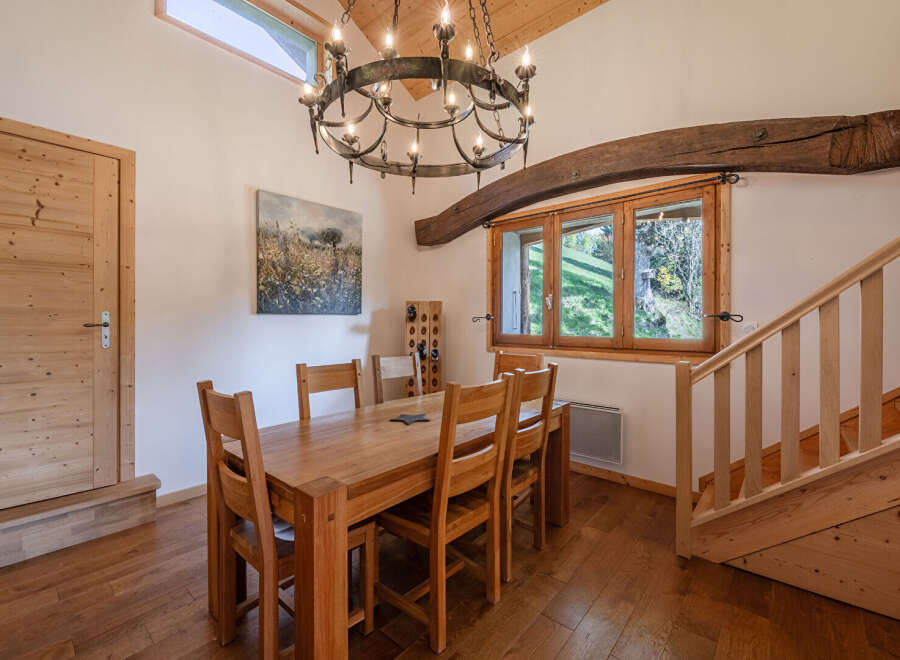 Step into this charming dining room, featuring a rustic wooden table and chairs, perfect for family gatherings.