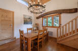 Step into this charming dining room, featuring a rustic wooden table and chairs, perfect for family gatherings.