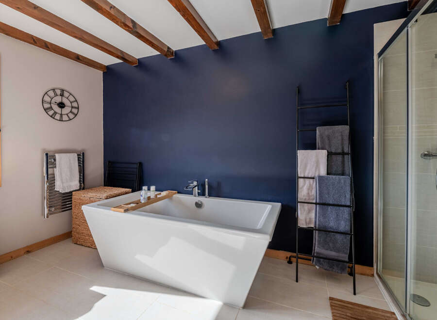 This luxurious bathroom features a modern freestanding bathtub, perfect for relaxing after a long day.