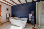 This luxurious bathroom features a modern freestanding bathtub, perfect for relaxing after a long day.