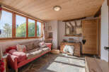 Discover the charm of this cozy living space, featuring a warm wooden ceiling and inviting natural light.