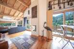 Experience the charm of this stunning property, featuring a spacious living area with a cozy fireplace and a beautiful wooden ceiling.