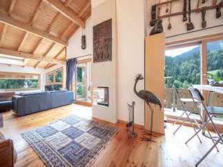 Experience the charm of this stunning property, featuring a spacious living area with a cozy fireplace and a beautiful wooden ceiling.