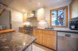 This charming kitchen boasts a modern design with ample counter space and storage.