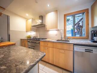 This charming kitchen boasts a modern design with ample counter space and storage.
