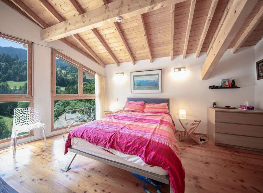 Experience the tranquility of this stunning bedroom with breathtaking mountain views.
