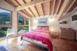 Experience the tranquility of this stunning bedroom with breathtaking mountain views.