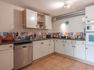 Discover the charm of this well-equipped kitchen, perfect for culinary enthusiasts.