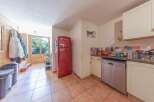 Discover this charming property featuring a well-equipped kitchen with a stylish red refrigerator.