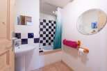 Discover this charming bathroom featuring a unique black and white checkered tile design, creating a stylish and modern aesthetic.