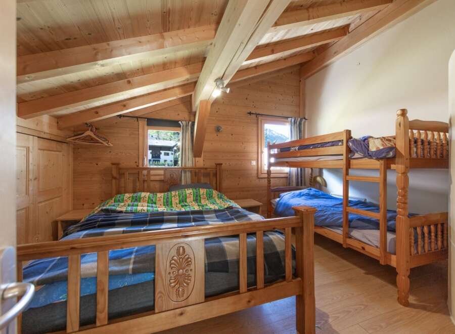 This charming bedroom features a cozy wooden interior, creating a warm and inviting atmosphere.