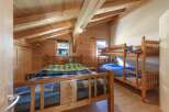 This charming bedroom features a cozy wooden interior, creating a warm and inviting atmosphere.