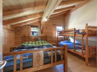 This charming bedroom features a cozy wooden interior, creating a warm and inviting atmosphere.