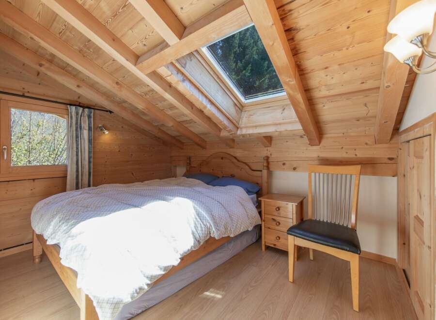 This charming bedroom features a cozy wooden interior, creating a warm and inviting atmosphere.