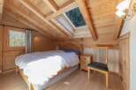 This charming bedroom features a cozy wooden interior, creating a warm and inviting atmosphere.
