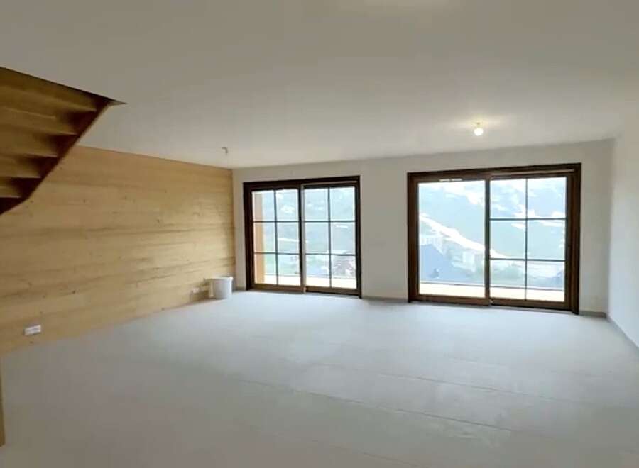 Experience breathtaking mountain views from this spacious, unfinished living area.