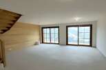 Experience breathtaking mountain views from this spacious, unfinished living area.