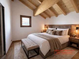 Experience luxury in this stunning bedroom featuring a cozy bed, elegant bench, and a warm, inviting atmosphere.