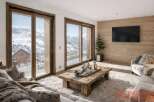 Experience luxury living in this stunning property, featuring breathtaking mountain views visible through expansive windows.