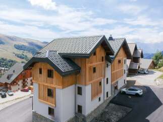 Discover modern mountain living in this stunning property featuring a blend of natural wood and stone accents.