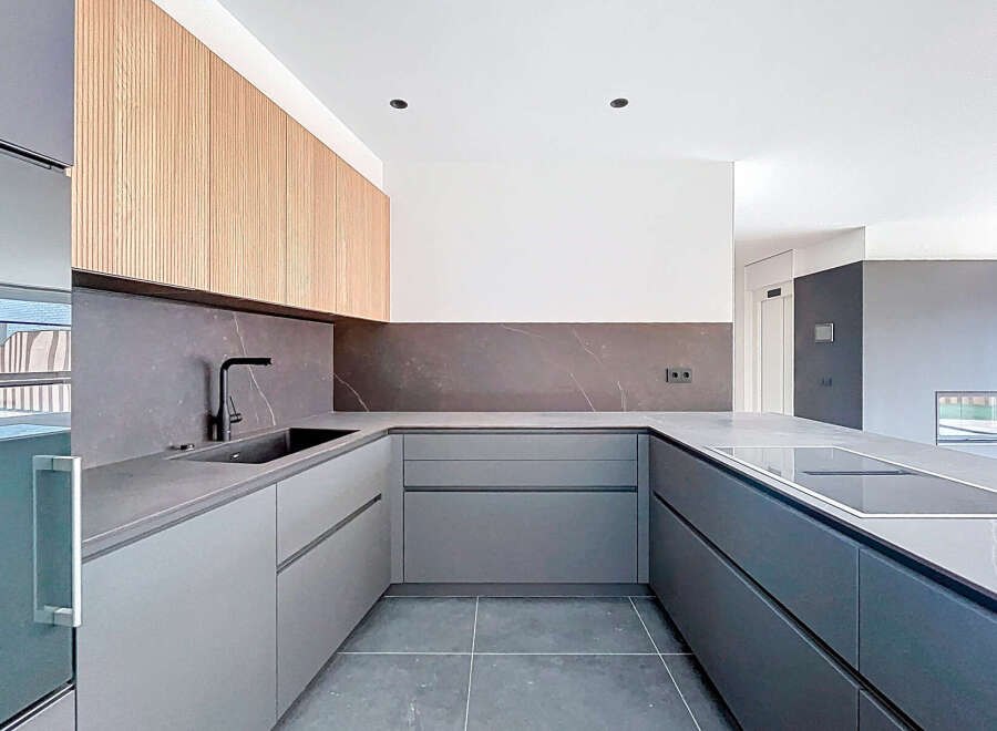 This modern kitchen boasts sleek, minimalist design with high-end finishes.