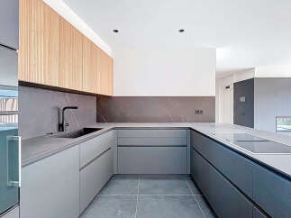 This modern kitchen boasts sleek, minimalist design with high-end finishes.