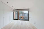 This modern bedroom boasts a minimalist design with clean lines and ample natural light.
