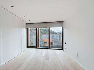 This modern bedroom boasts a minimalist design with clean lines and ample natural light.