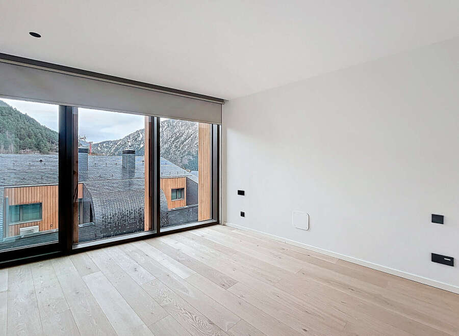 Experience the epitome of modern living in this stunning property, boasting expansive windows that frame breathtaking mountain views.