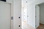 Step into a modern, minimalist hallway with clean lines and a bright, airy feel.