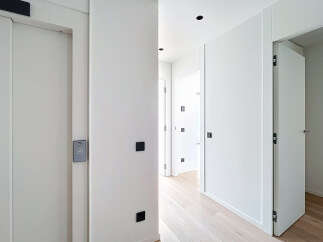 Step into a modern, minimalist hallway with clean lines and a bright, airy feel.
