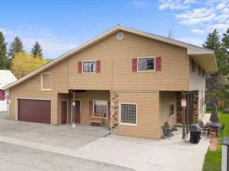 This stunning property boasts a unique architectural design with a blend of modern and rustic elements.