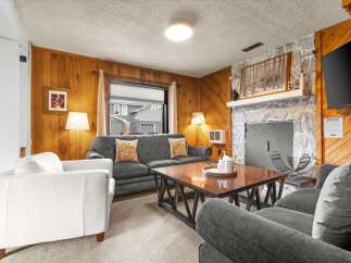 Step into a cozy living space with a charming stone fireplace, perfect for those chilly evenings.