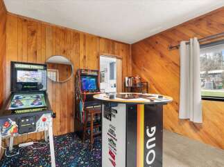 Step into a retro gaming paradise! This unique space features a Legends Pinball machine and a Mortal Kombat arcade game, perfect for endless entertainment.