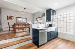 This stunning kitchen features a modern design with sleek blue cabinetry and a stainless steel dishwasher.