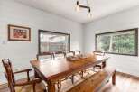 Step into this inviting dining room, showcasing a rustic wooden table and bench, perfect for family gatherings.