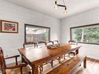 Step into this inviting dining room, showcasing a rustic wooden table and bench, perfect for family gatherings.