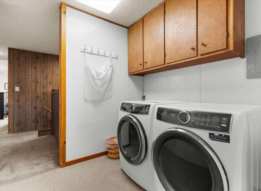 Discover the convenience of this well-appointed laundry room, featuring modern appliances and ample storage.