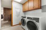 Discover the convenience of this well-appointed laundry room, featuring modern appliances and ample storage.