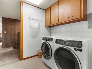 Discover the convenience of this well-appointed laundry room, featuring modern appliances and ample storage.