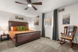 This inviting bedroom features a comfortable bed with stylish bedding and accent pillows, creating a cozy atmosphere.