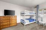 This cozy bedroom features a stylish bunk bed, perfect for accommodating guests or family members.