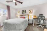 This inviting bedroom features a comfortable bed with a stylish headboard and elegant lamps.