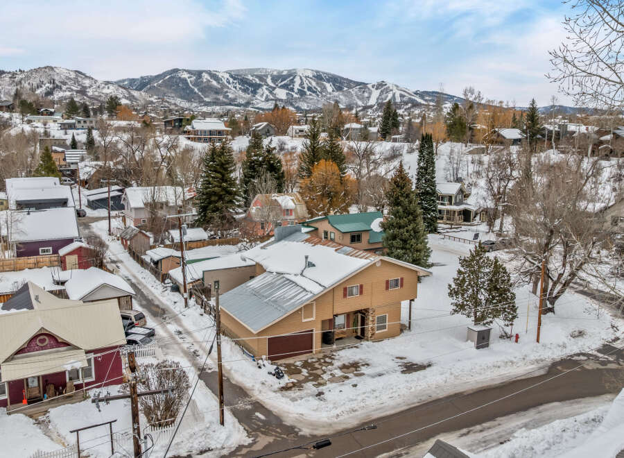 This charming property offers a cozy retreat in a picturesque winter setting.