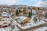This charming property offers a cozy retreat in a picturesque winter setting.